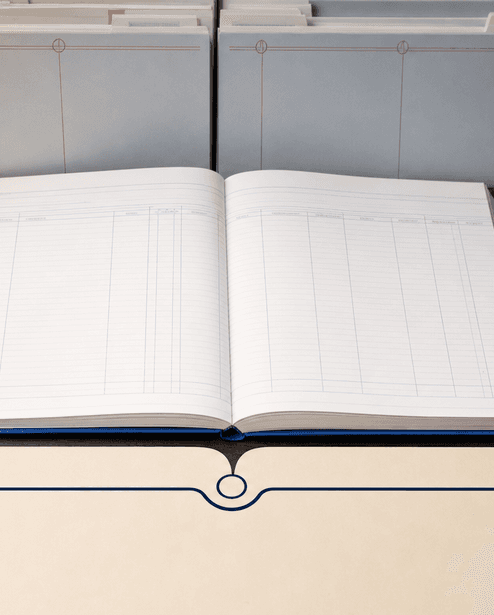 An open blank case register with ruled columns, beside filed evidence folders and reference tabs